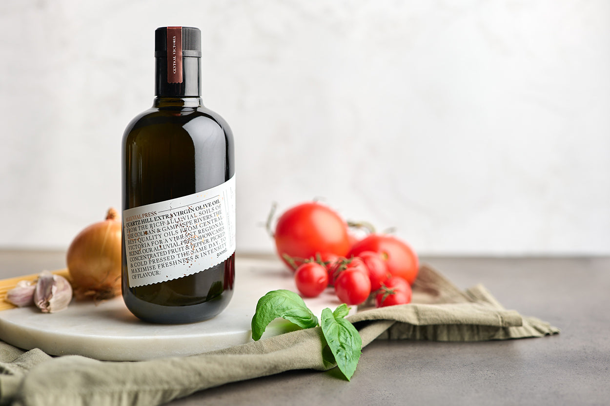 Black bottle with white label olive oil in kitchen ready for tomato olive oil recipe.