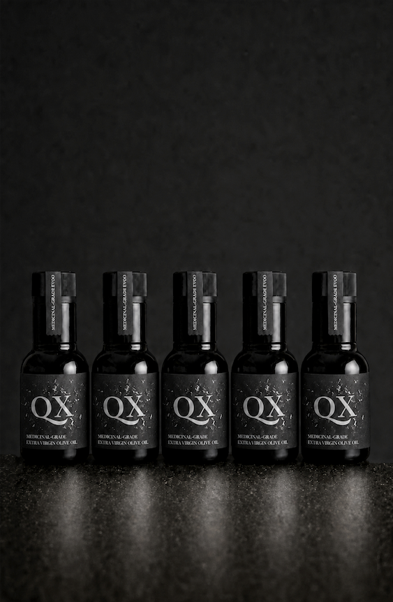 Five 100ml black bottles of QX Medicinal-Grade Extra Virgin Olive Oil arranged in a row against a dark background for a 30-day challenge