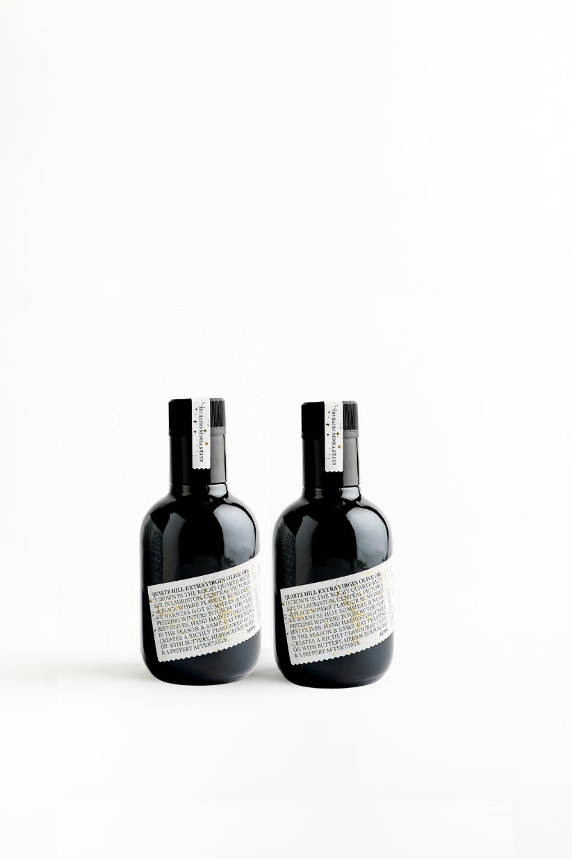 Two bottles of 250ml Australian Made High Polyphenol olive oil in a protective black bottle with white label.