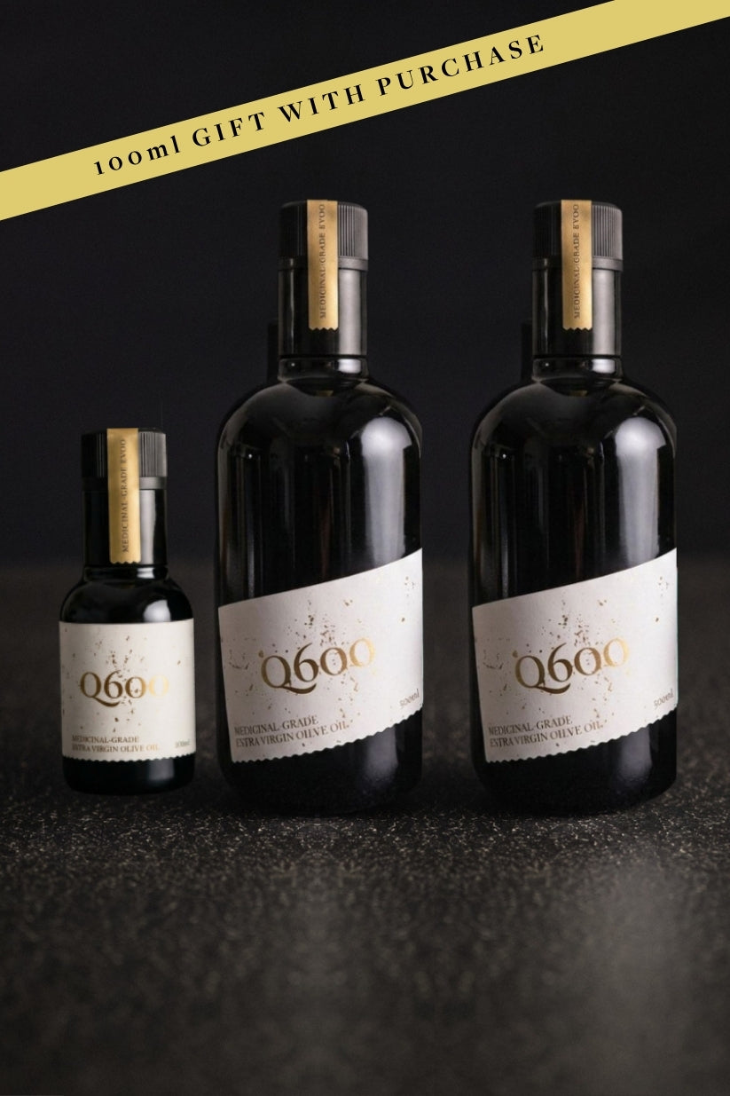 Images of 3 bottles of high-polyphenol australian EVOO: 2x 500ml and a gift with purchase 100ml on a black bench and black background.