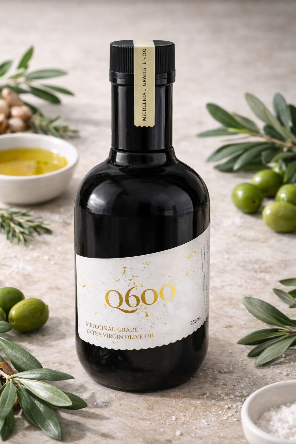 Dark glass bottle of Q600 medicinal-grade extra virgin olive oil on stone surface with fresh green olives and olive branches. Early-harvest, high polyphenol (550+ ppm) Australian olive oil designed for heart health, anti-inflammatory lifestyle, longevity, cognitive support and premium wellness nutrition.
